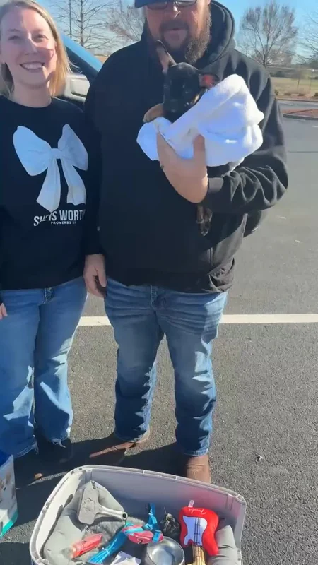 A family welcoming their First Pick puppy on pickup day